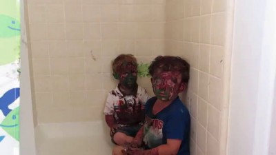 Kids play with paint a get it all over their faces