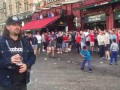 English hooligans are mocking at gipsy children throwing them coins