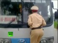 Video: Vietnam cop clings to speeding bus windshield wipers