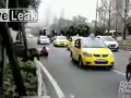Woman pisses towards oncoming traffic on road
